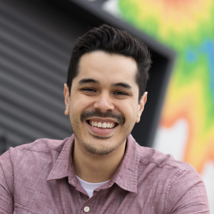 Anthony Gardes infront of a colorful wall